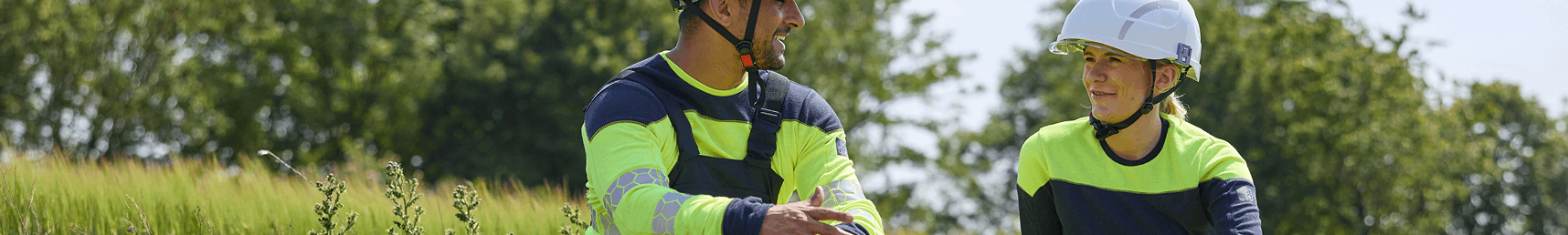 Two workers in safety gear conversing.